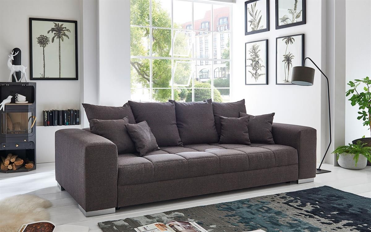 Ein Wohnzimmer mit einem großen Sofa und einem Teppich.