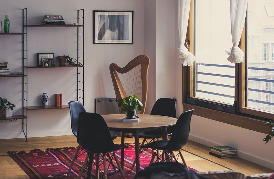 Ein Wohnzimmer mit einer Harfe und einem Tisch und Stühlen