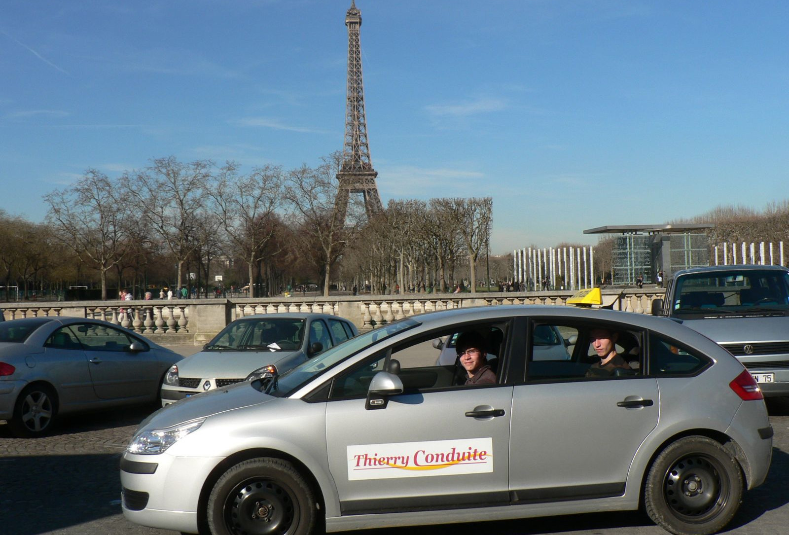 Véhicules Thierry Conduite devant Tour Eiffel