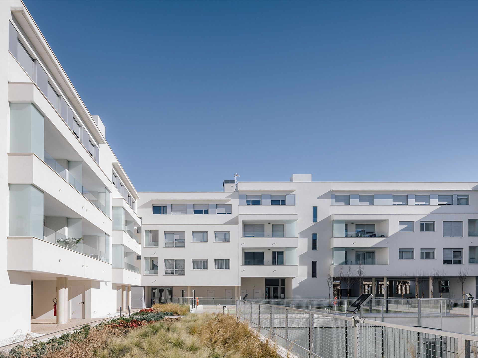 Un gran edificio blanco con muchas ventanas y balcones.