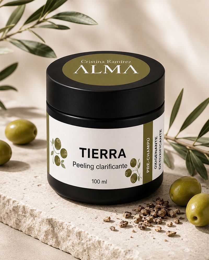 Tarro de crema para pelar ALMA Tierra sobre una superficie de piedra con ramas de olivo.