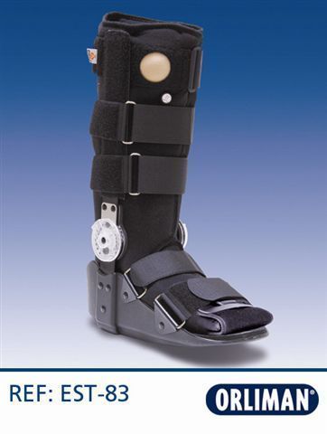 Bota ortopédica negra para caminar con correas y dial de ajuste blanco sobre fondo azul.
