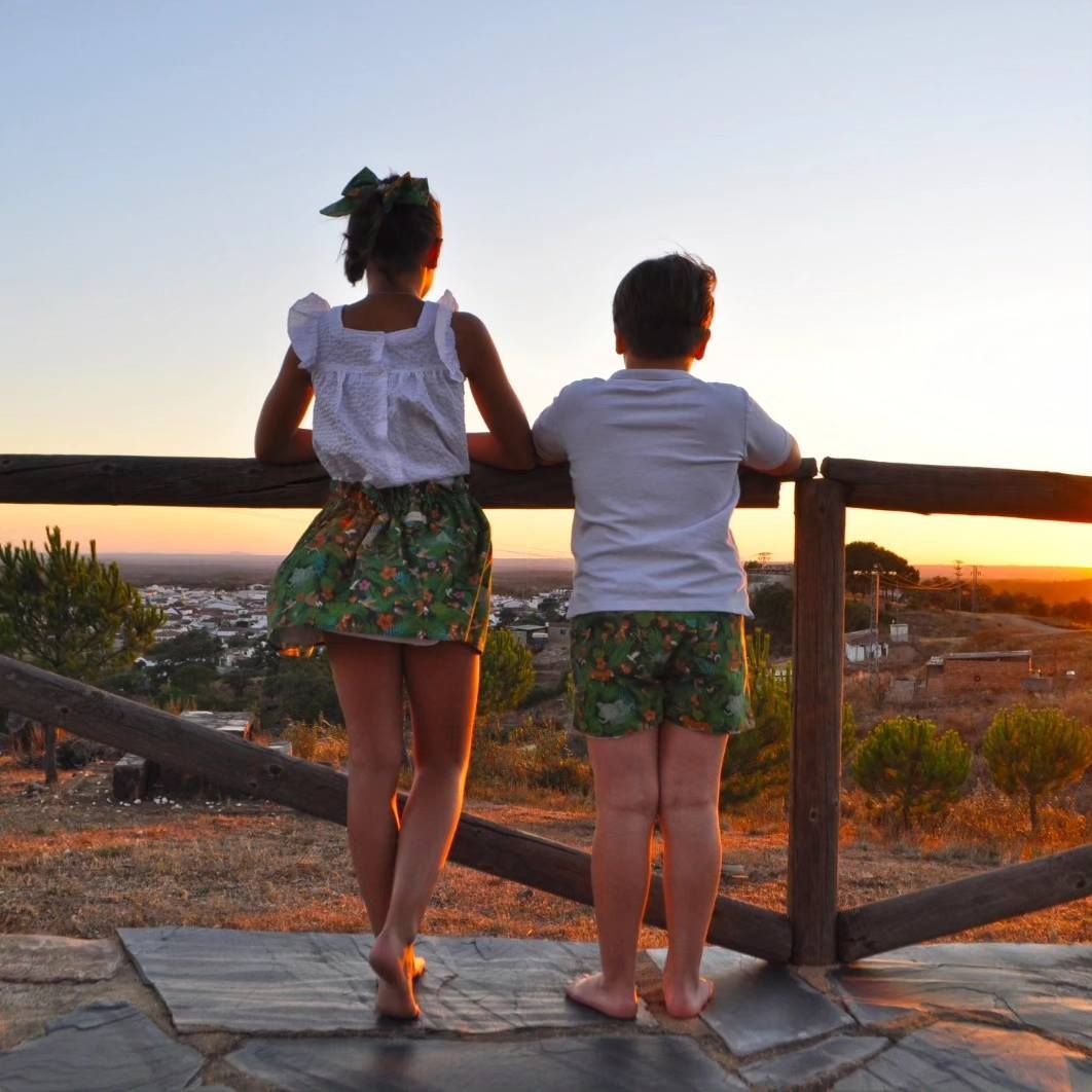 Dos mujeres paradas en un balcón mirando la puesta de sol