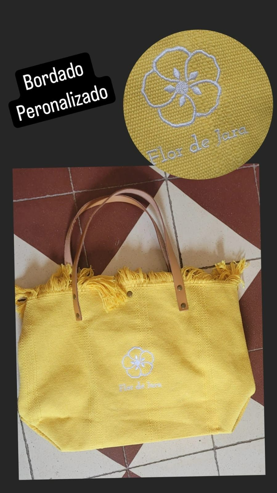 Una bolsa de mano amarilla con una flor bordada.