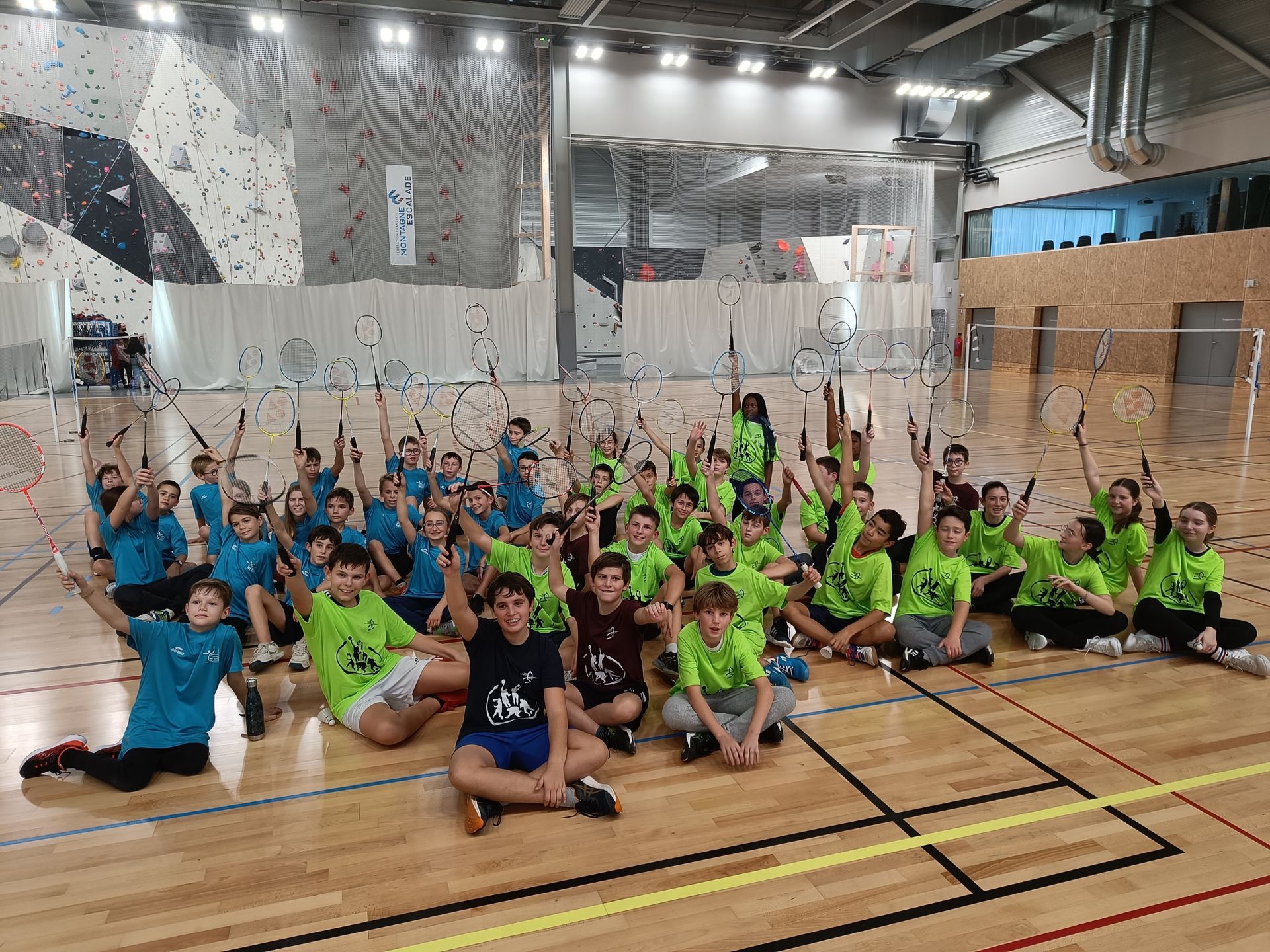 Équipe de badminton levant leurs raquettes