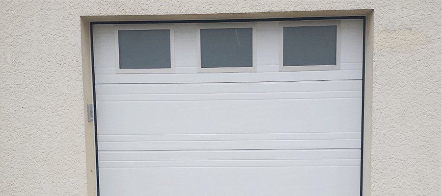 Porte de garage blanche avec trois vitres