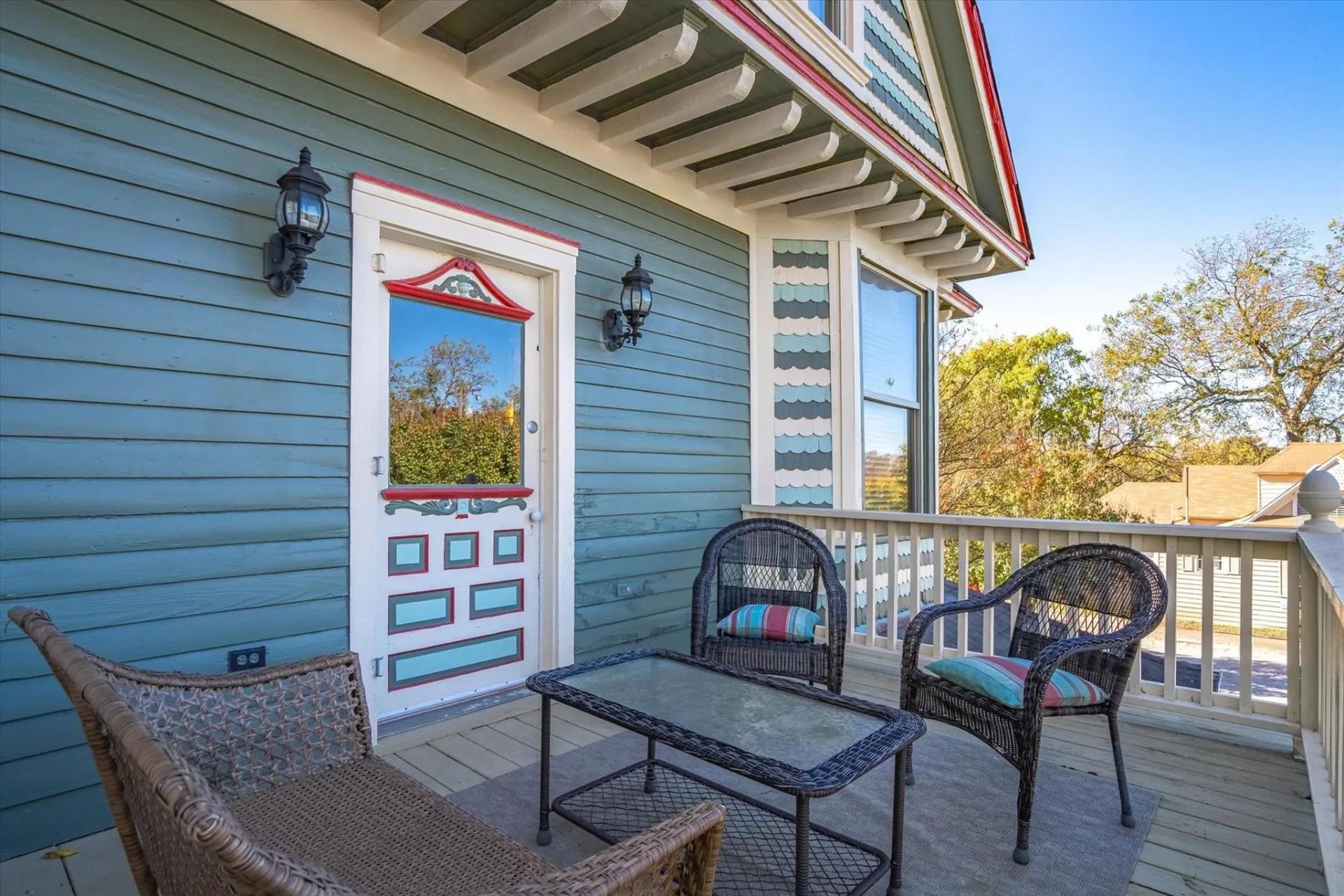 There is a balcony with chairs and a table on it.