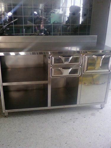 Un armario de acero inoxidable con cajones y estantes en una cocina.