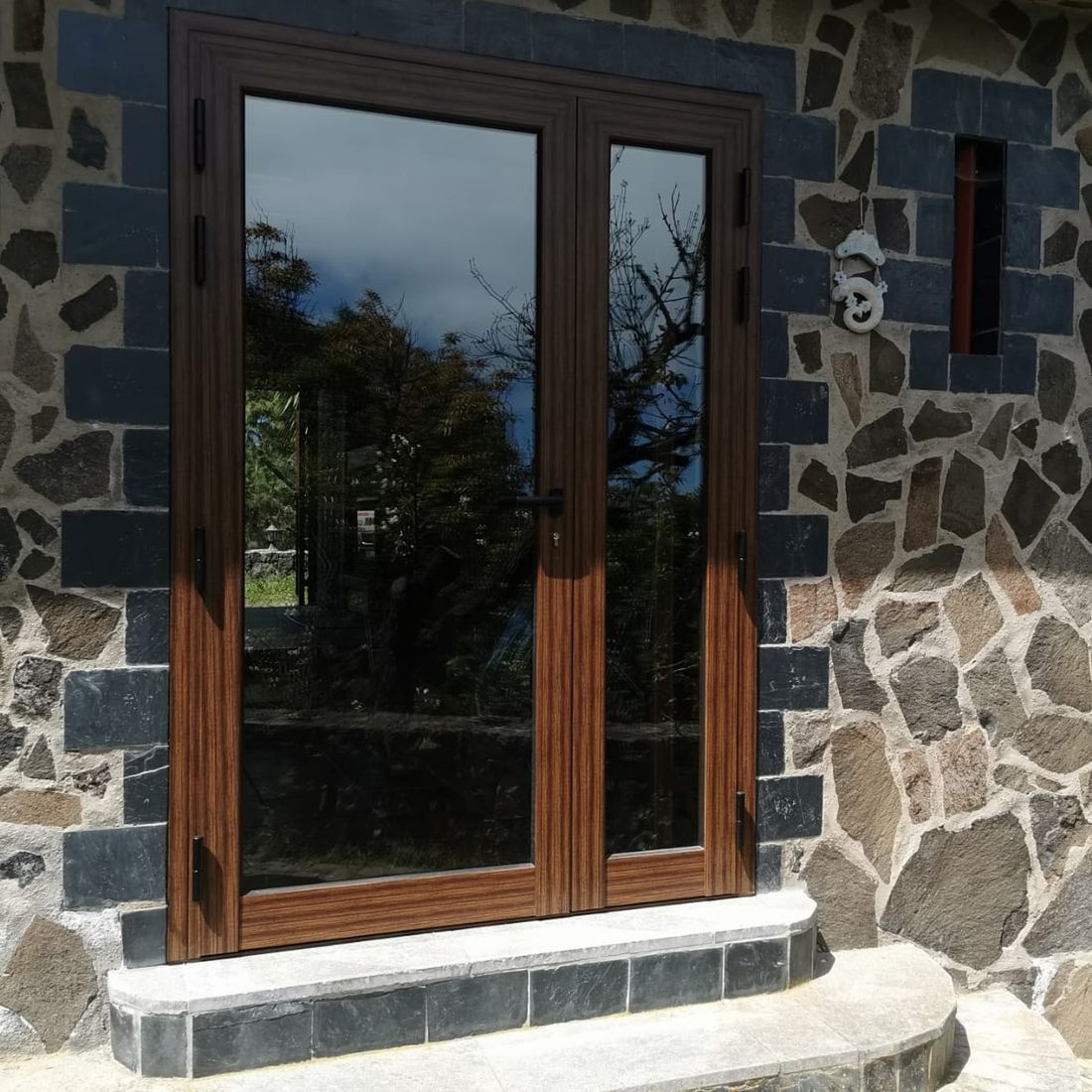 Un edificio de piedra con una puerta y escalones de madera.