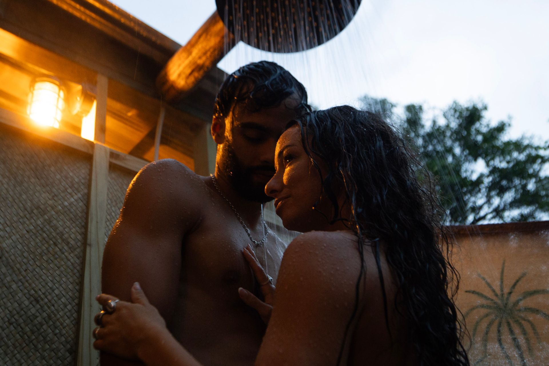 A couple sharing a private outdoor rainfall shower
