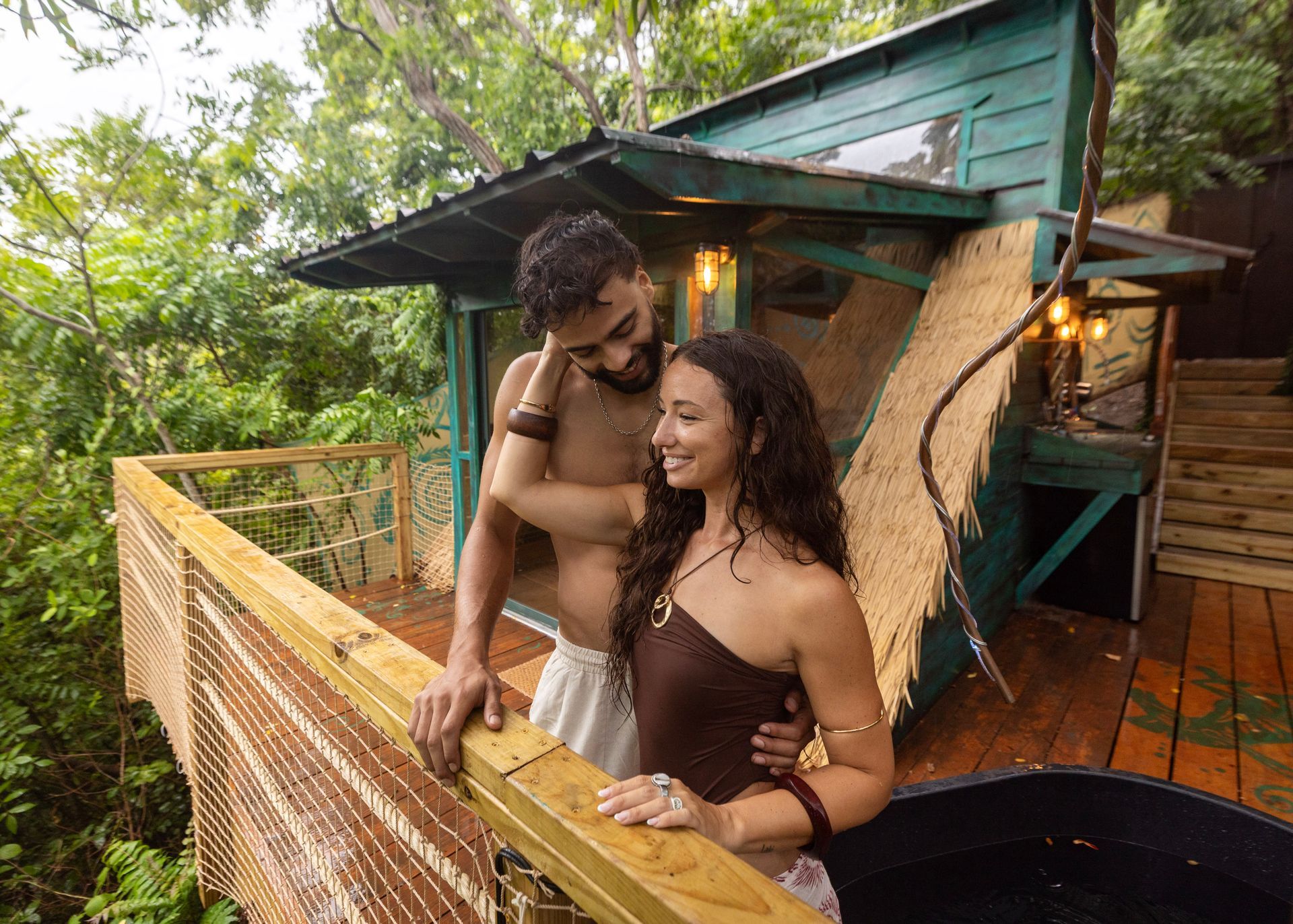 A couple together on a secluded Jungle deck surrounded by tropical greenery