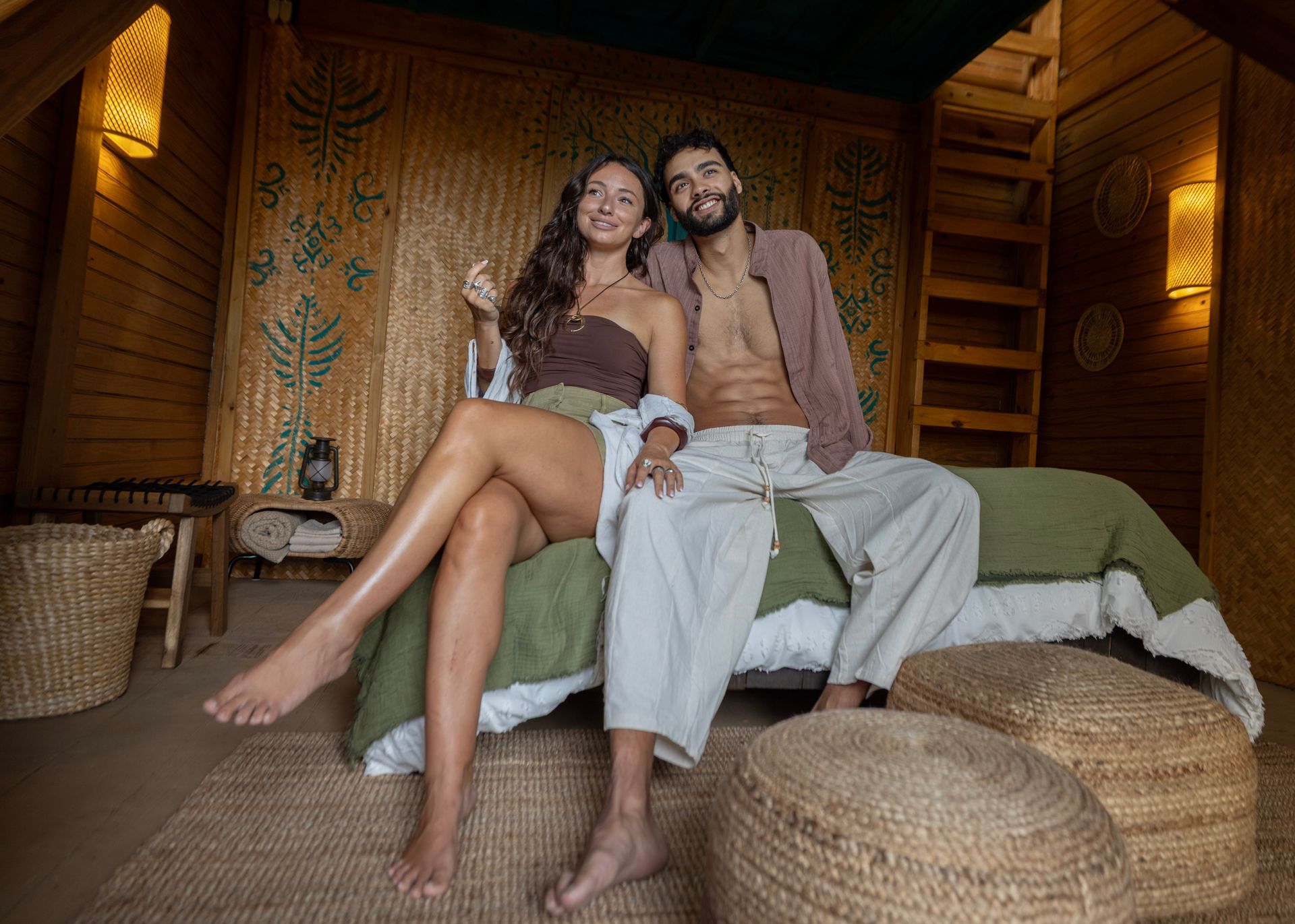 A couple relaxing together inside their Jungle accommodation
