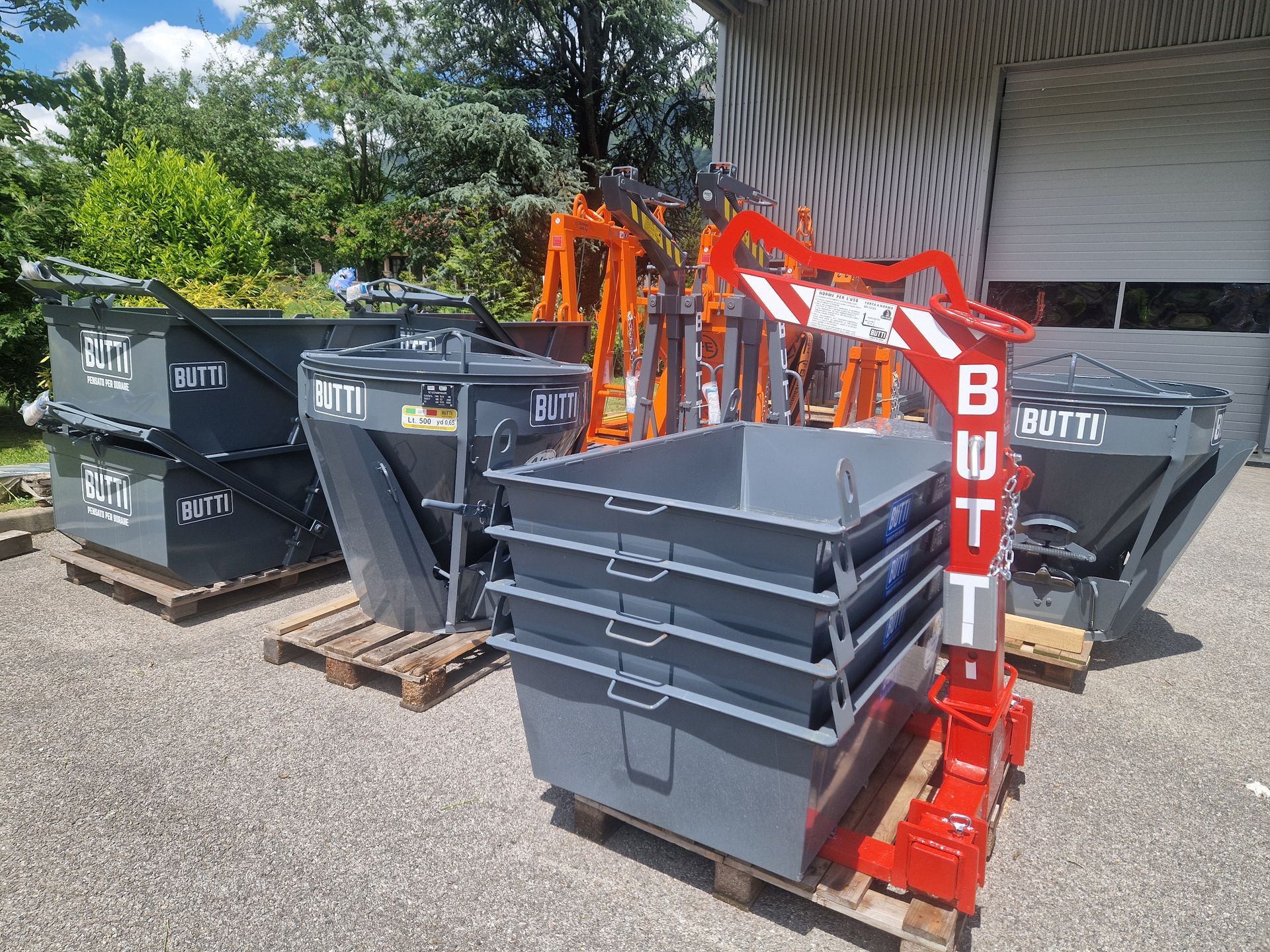 Une collection de bennes à gravats et bennes à béton, en extérieur.