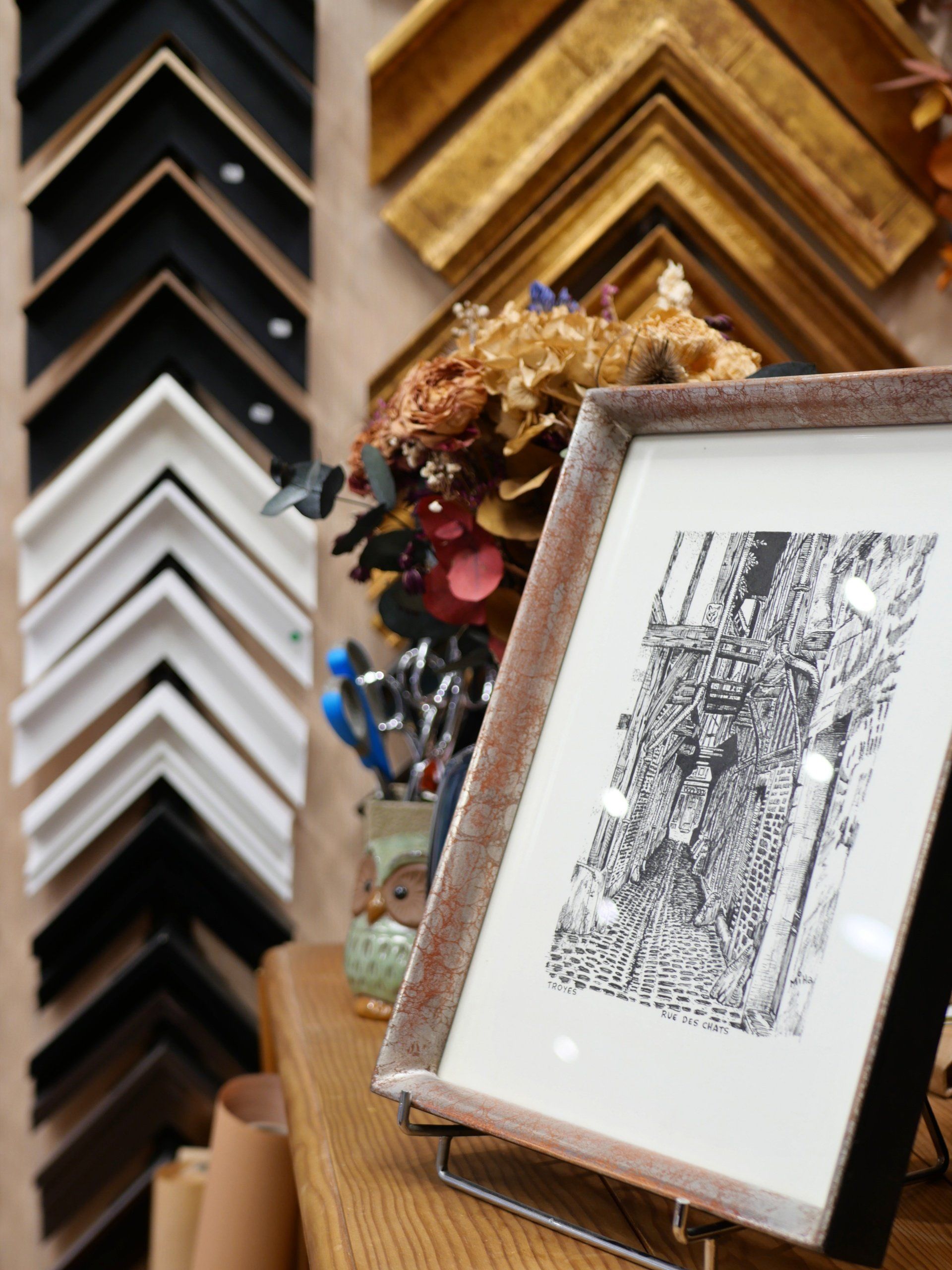 Dessin noir et blanc dans un cadre avec des baguettes en arrière