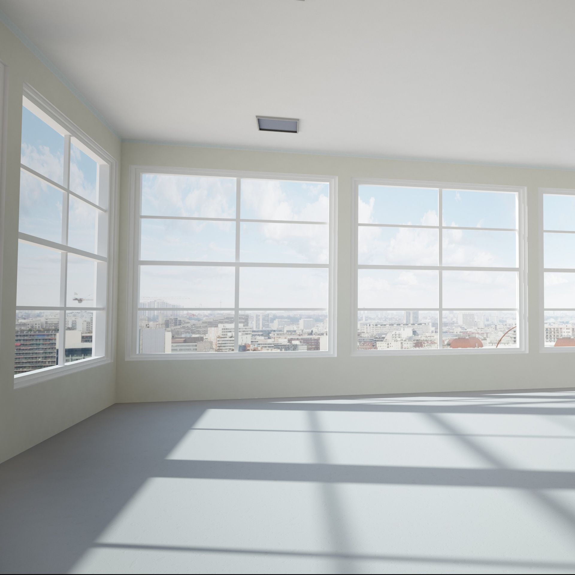 Una habitación vacía con muchas ventanas y vistas a la ciudad.