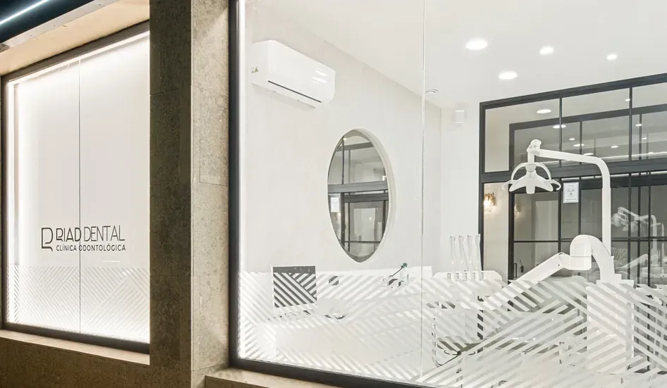 Un consultorio dental con un sillón dental en la ventana.