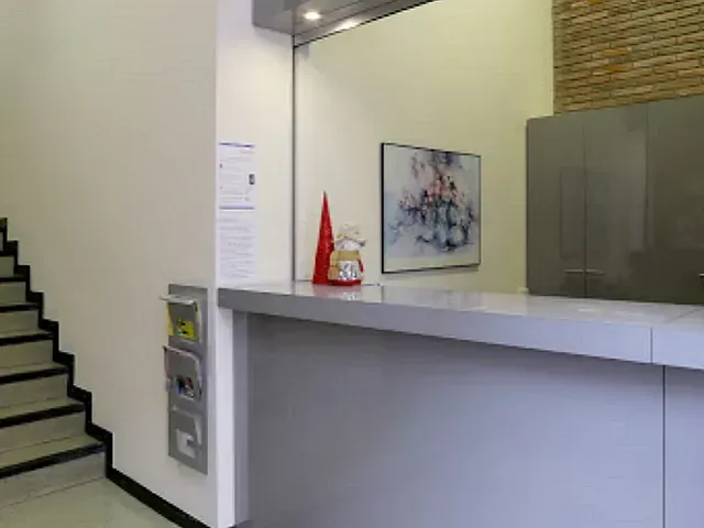 Un mostrador en una habitación con escaleras y un cuadro en la pared.