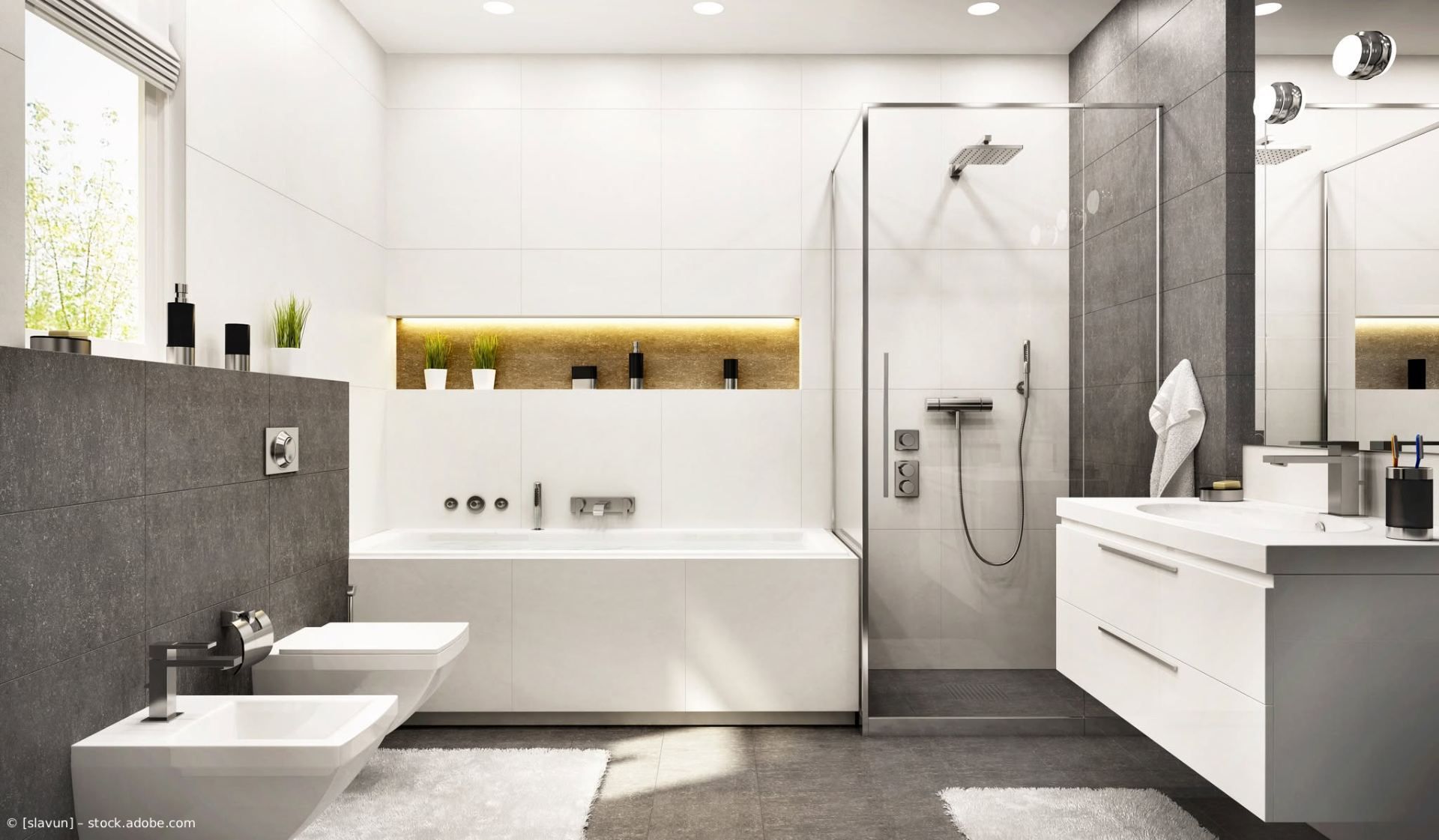 Modernes weiß-graues Badezimmer mit Badewanne, Dusche, Doppelwaschbecken und wandhängendem WC