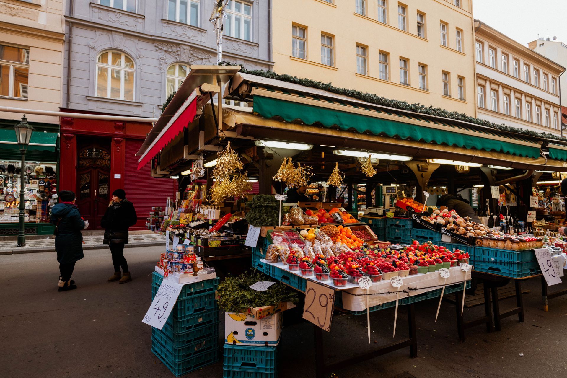 Fruit and vegetable stalls lining a busy city street market, like the York Food and Drink Festival o