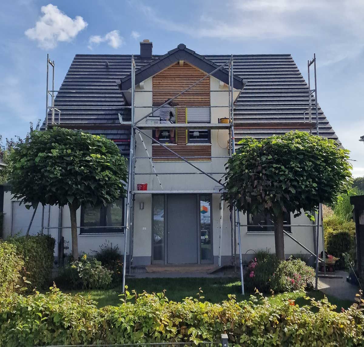 ein Haus mit einem Gerüst davor und einem Schild darauf - Referenzen der Malermeisterin Stefanie Würfel aus Bielefeld