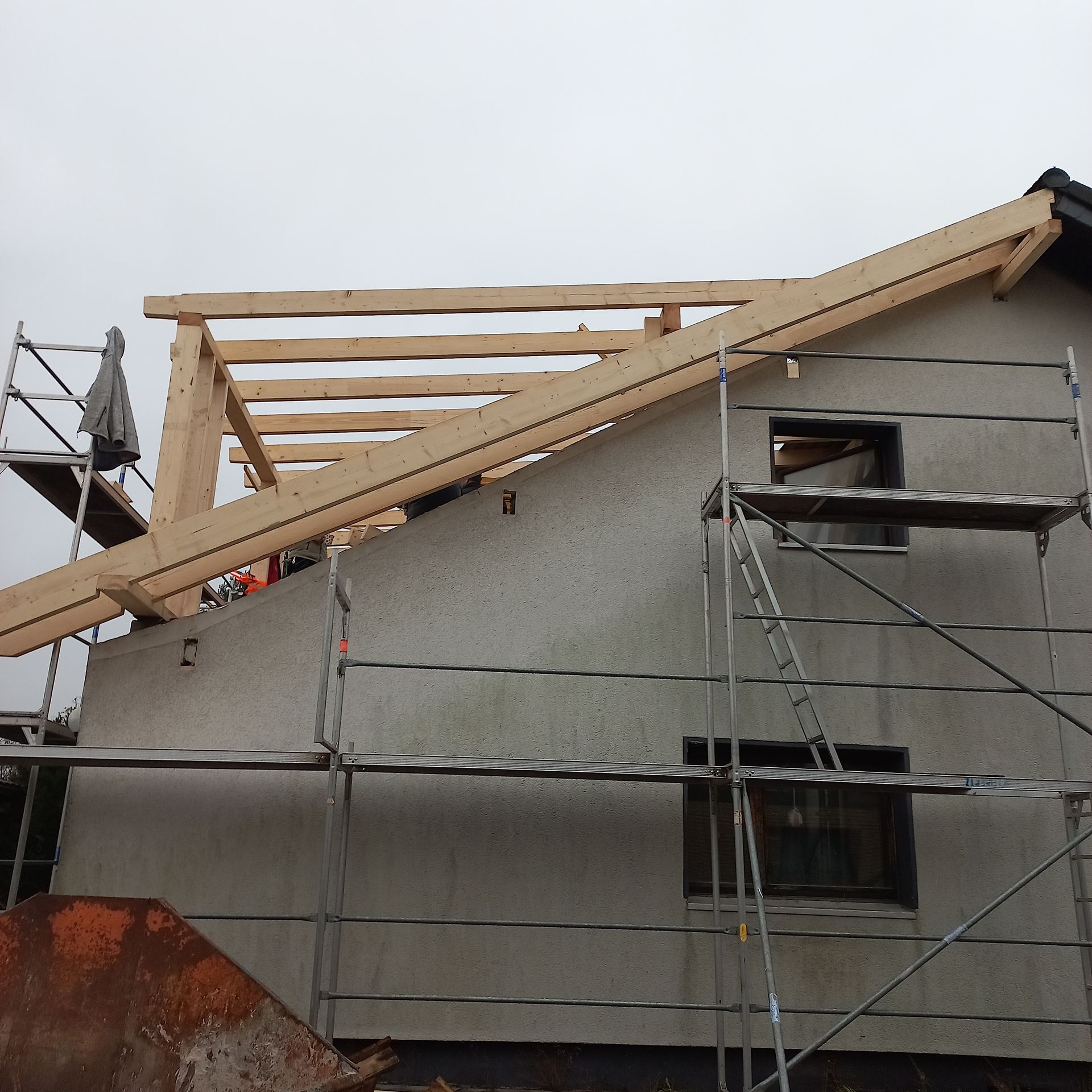 Ein im Bau befindliches Gebäude mit Gerüst und einem Holzdach