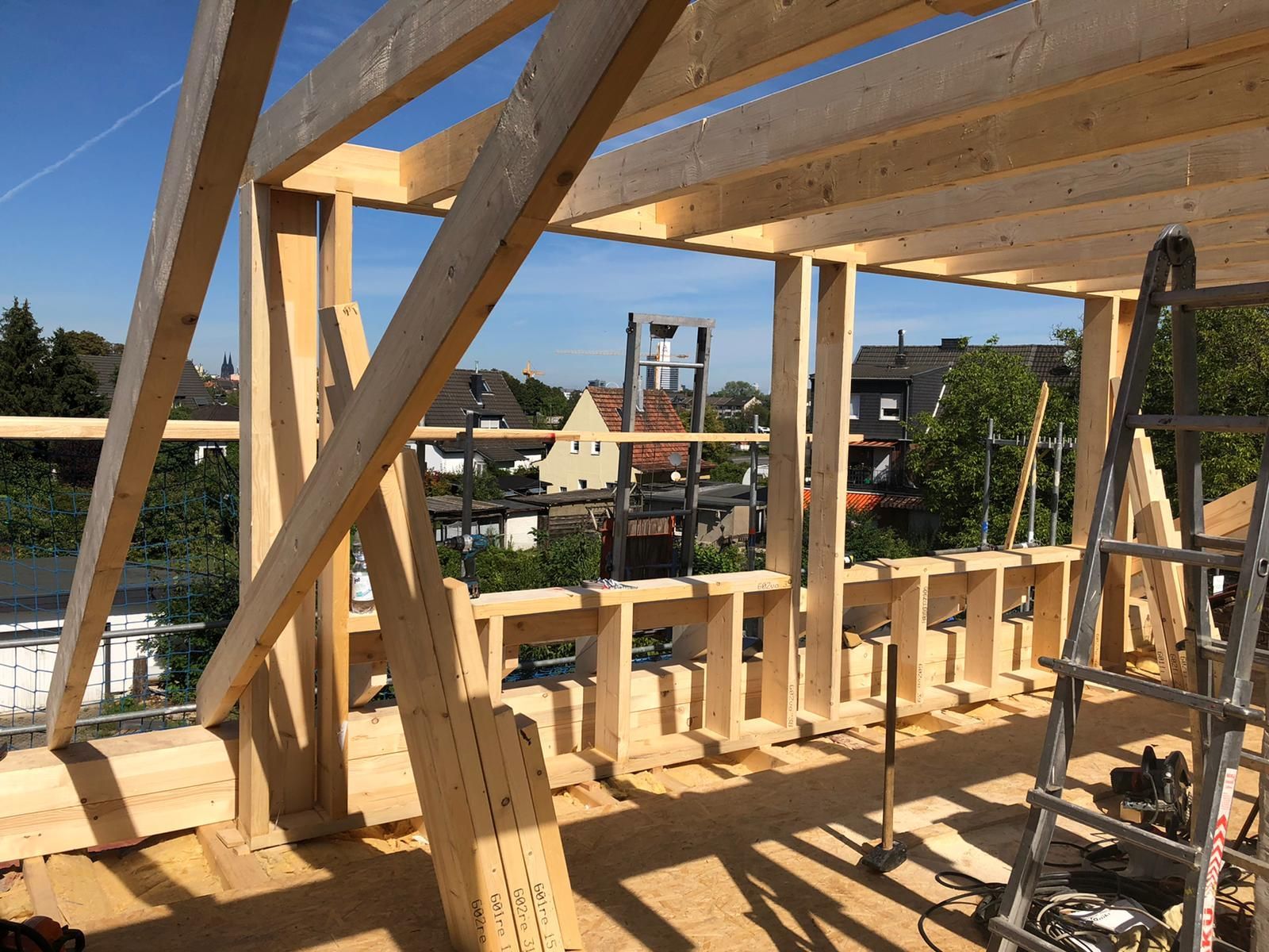 Es wird eine Holzkonstruktion errichtet, im Vordergrund ist eine Leiter zu sehen.