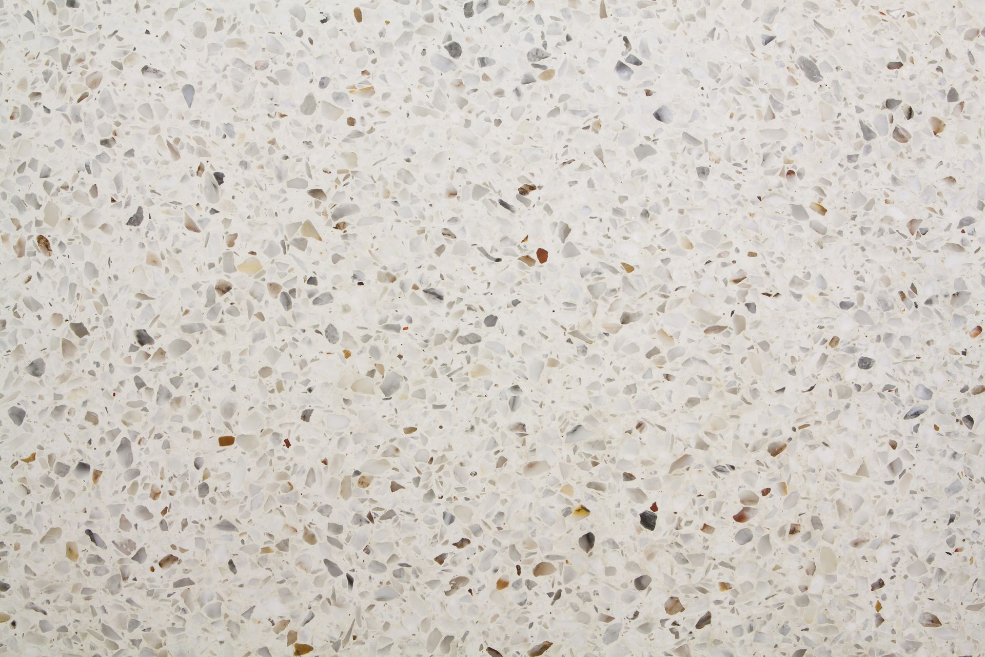Surface en pierre ou en terrazzo beige clair moucheté de petites taches grises et brunes