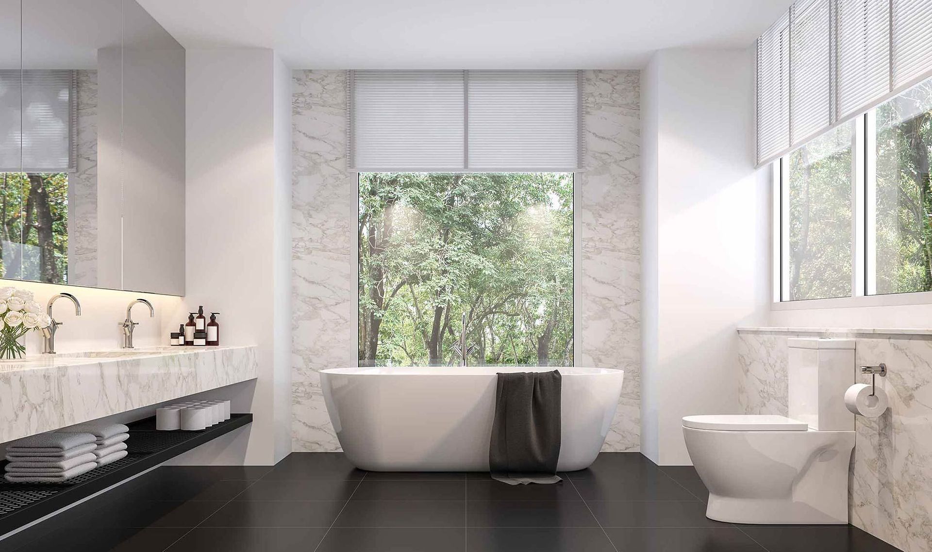 Modernes Badezimmer mit weißer Badewanne, Toilette und großem Fenster mit Waldblick.