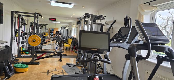 The guest gym at The Grumpy Schnauzer Hot Tub Suites
