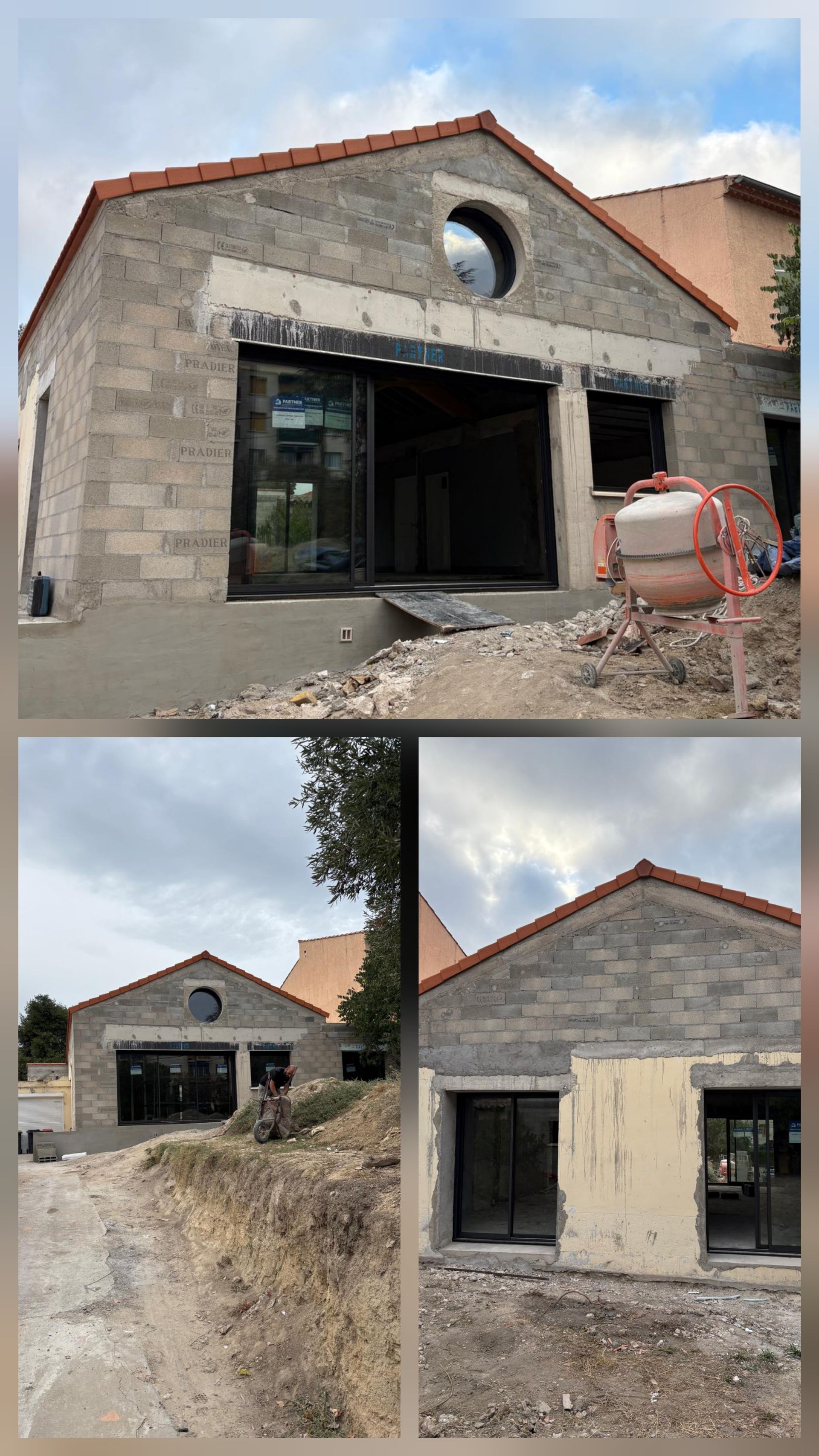 Bâtiment en construction avec des murs en pierre grise, un toit de tuiles rouges et de grandes fenêtres.