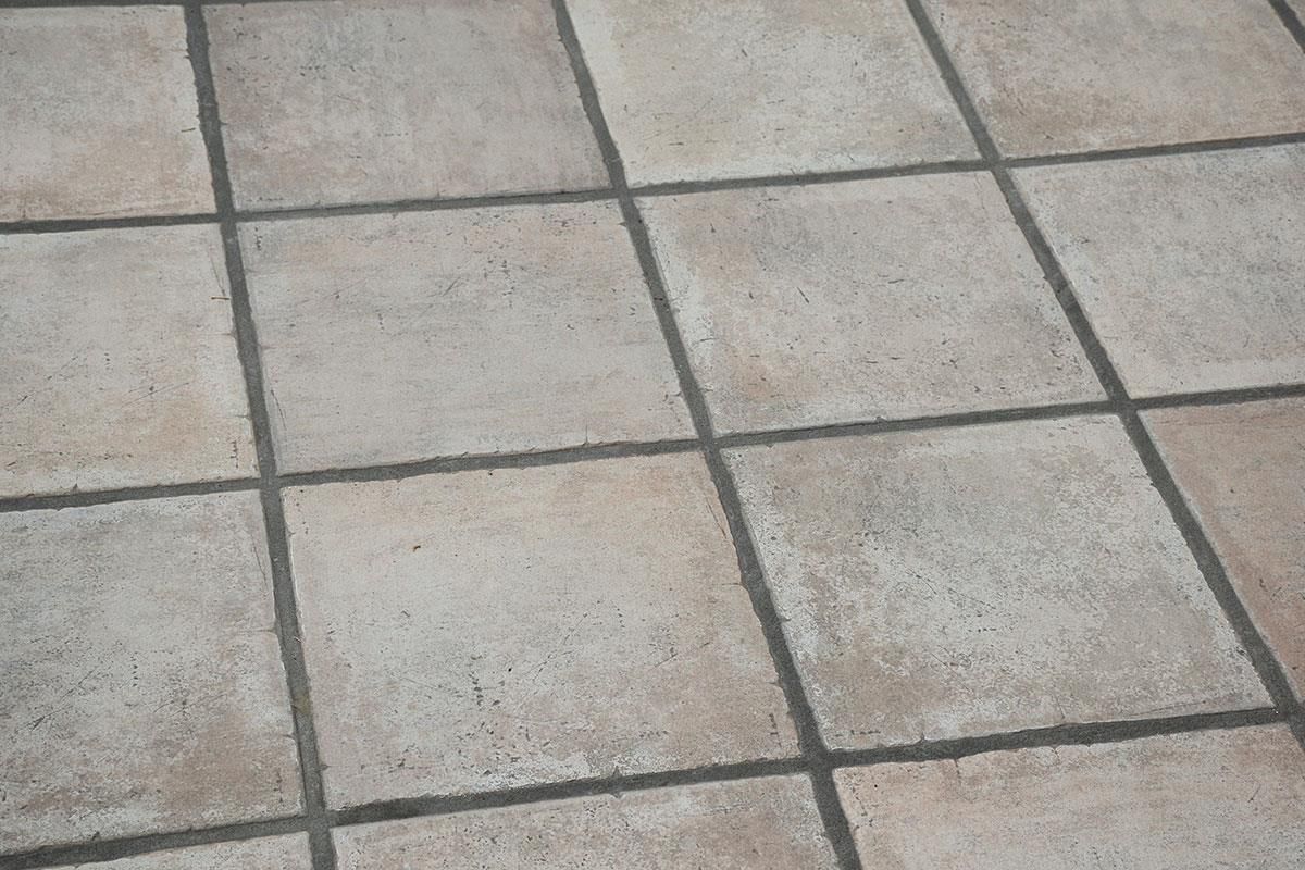 Eine Nahaufnahme eines gefliesten Bodens mit einem schwarzen Rand