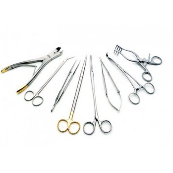 Surgical instruments, including scissors, forceps, and a bone cutter, are arranged on a white surface.
