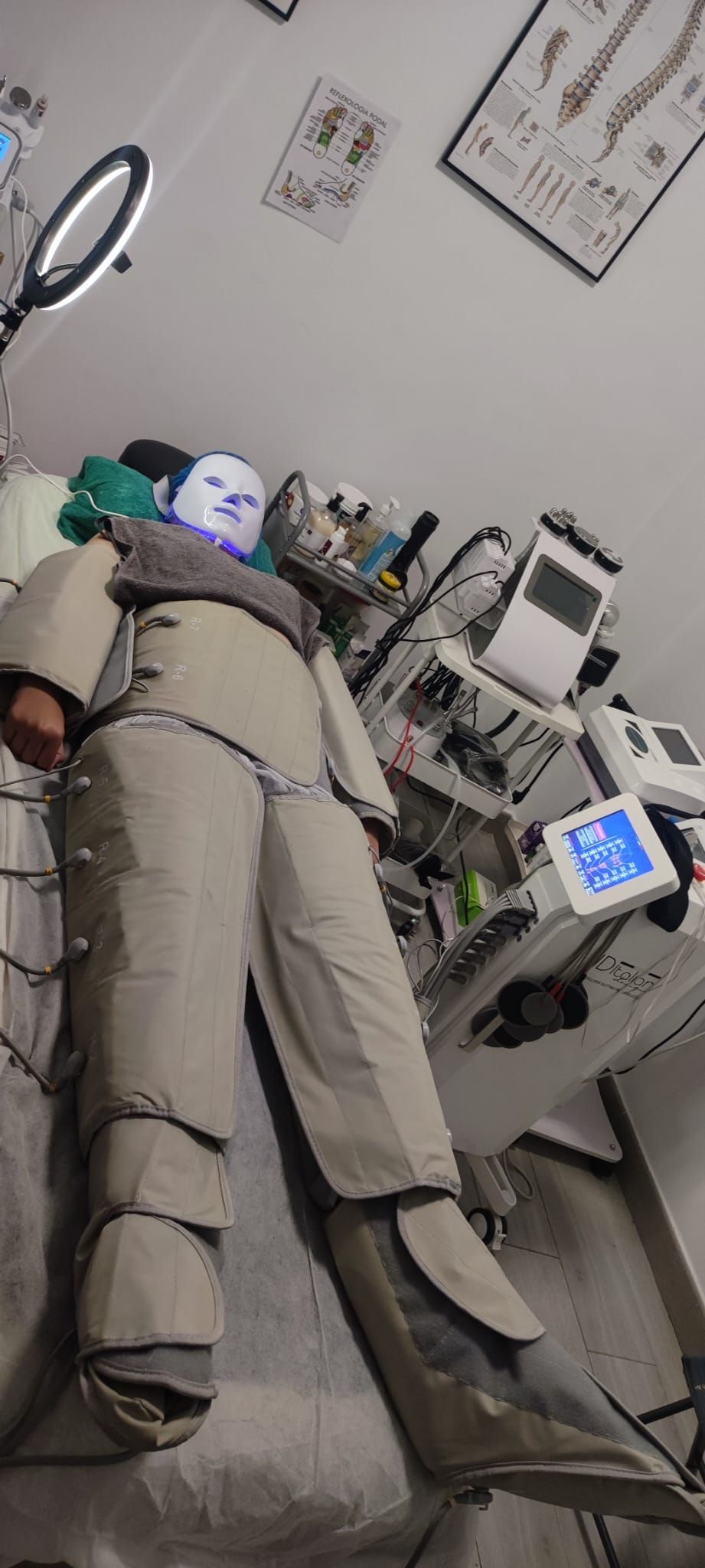 Una persona está acostada en una cama en una habitación con un anillo de luz.