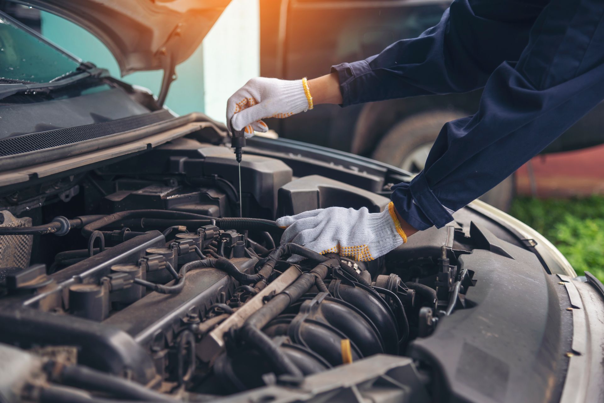 Ein Mechaniker prüft den Ölstand eines Autos.