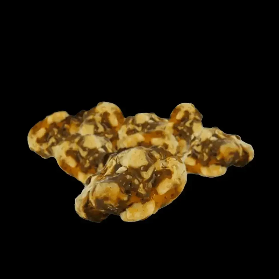 Grupos de palomitas de maíz con caramelo y llovizna de chocolate negro sobre un fondo negro.