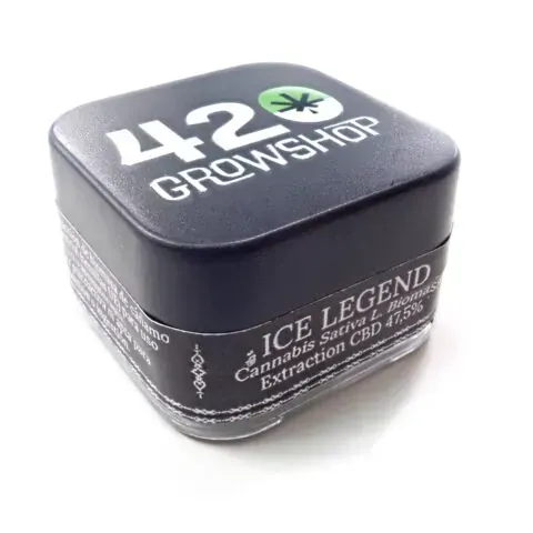 Masa de hachís granulada de color canela sobre una superficie blanca.