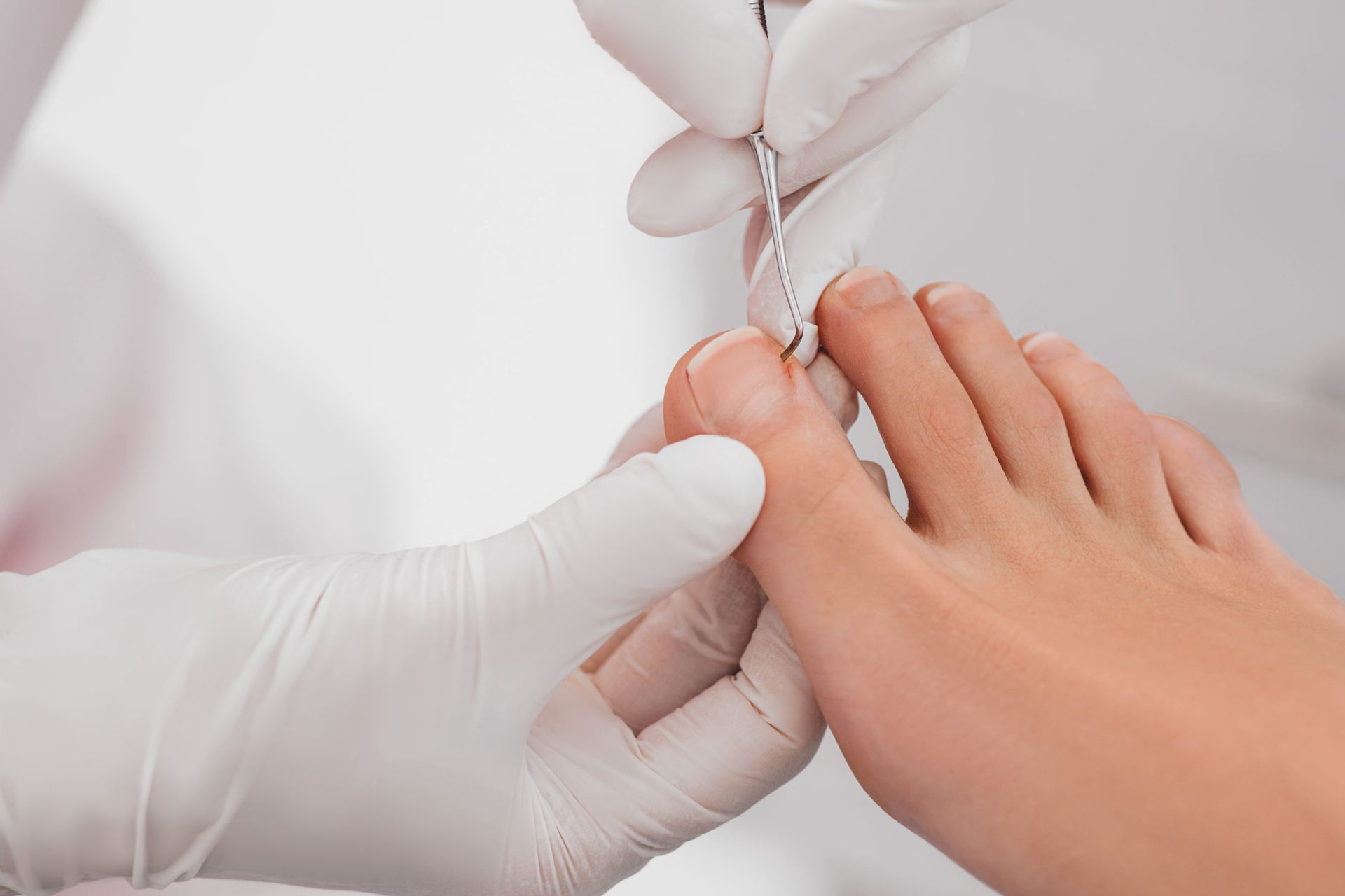 Una persona se está haciendo cortar las uñas de los pies con un técnico de uñas.