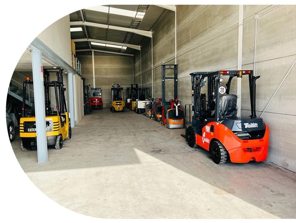 Un montón de carretillas elevadoras están estacionadas en un almacén