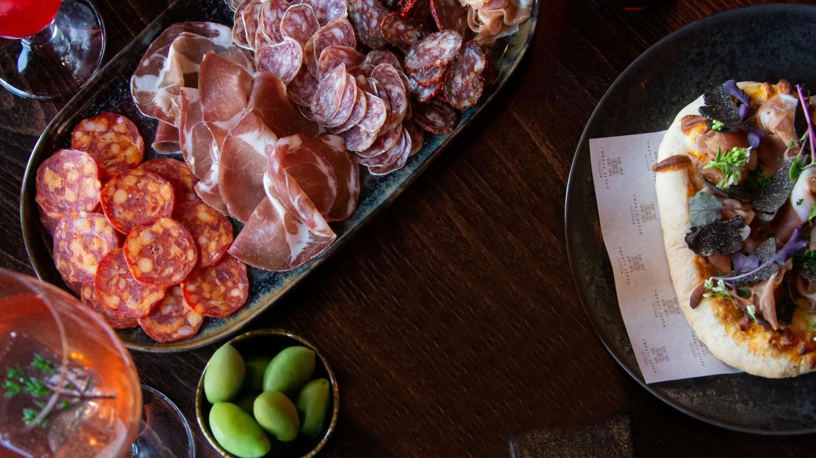 A table topped with plates of food and drinks.