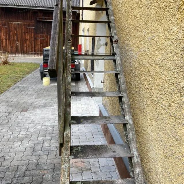 Eine alte Holztreppe, die zu einem Gebäude hinaufführt