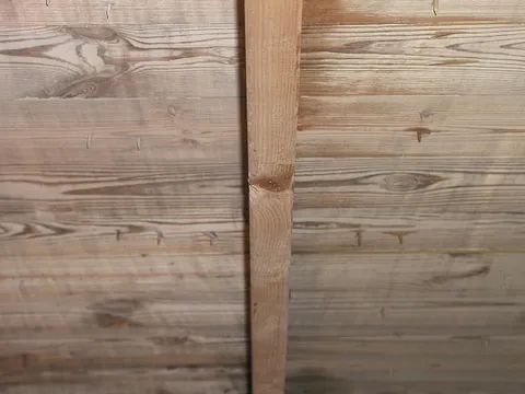 Eine Nahaufnahme eines Holzstücks an einer Wand.