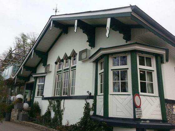 Ein weißes Haus mit grüner Verzierung hat ein Parkverbotsschild davor