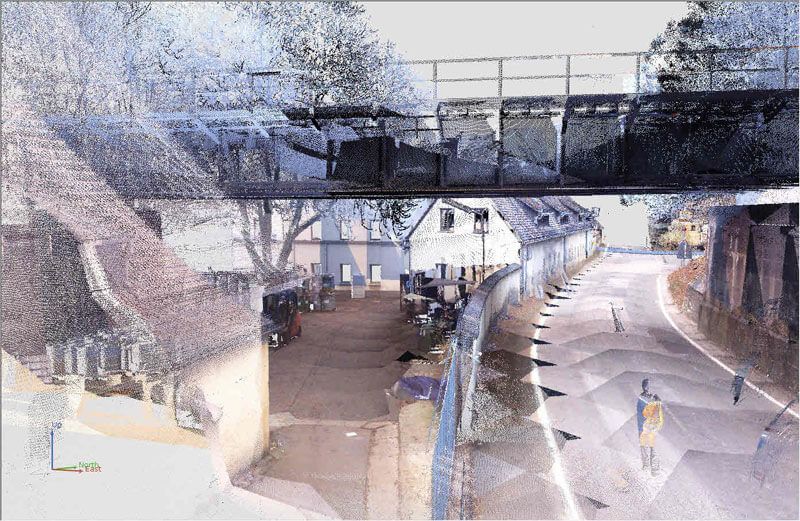 Punktwolkenvisualisierung einer Straße mit Gebäuden, einer Brücke und einer Straße.