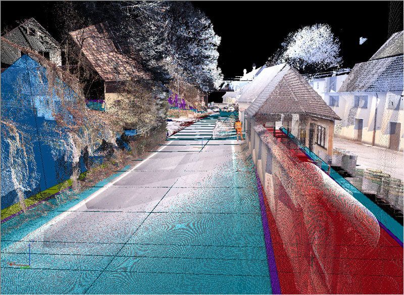 Punktwolkenscan einer Straße, der Gebäude und Straße zeigt; mehrfarbig, mit dunklem Himmel.