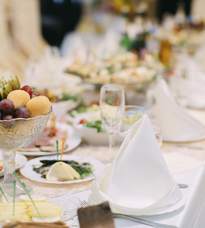 Una mesa cubierta con platos de comida y un bol de fruta.