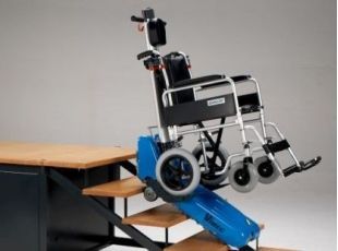 Mujer en silla de ruedas en una plataforma elevadora roja subiendo una escalera interior.