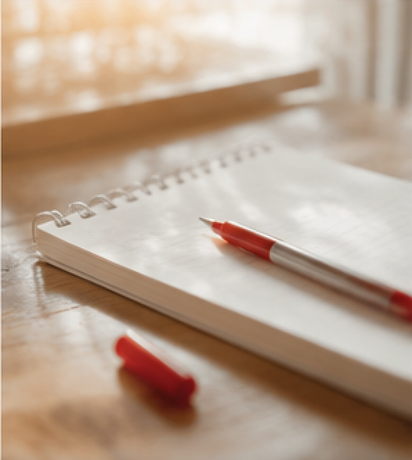 Rotstift auf Notizblock