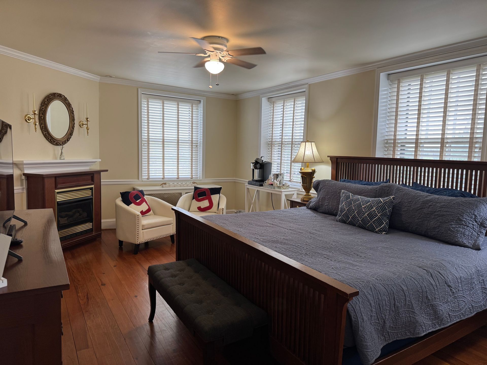 A bedroom with a king size bed and a fireplace