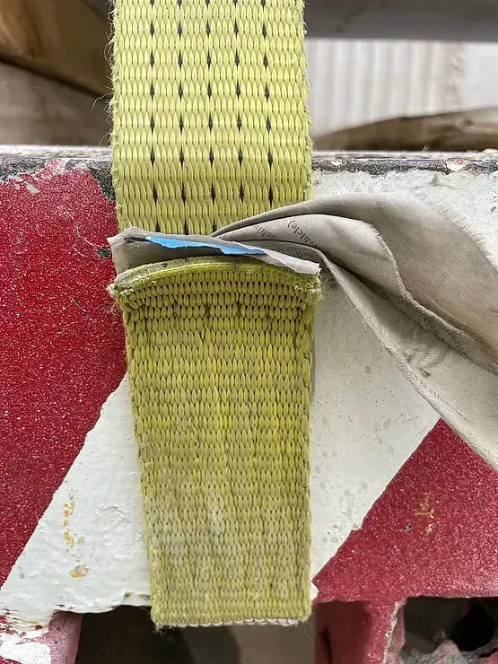 Un primer plano de una correa amarilla en un objeto rojo y blanco.