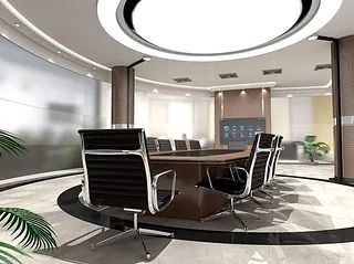 Moderna sala de conferencias con mesa, sillas, pantalla grande y luz natural.